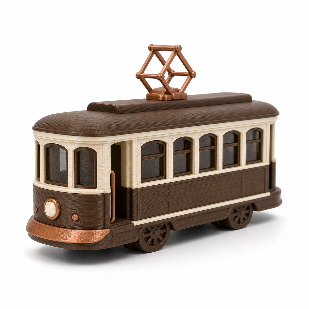Product illustration of "Decorative tram model in brown" on white background: vehicle figure; Basic shape: elongated tram with multiple windows and roof pickup; Design: elaborated doors, wheels and a classically structured front; Colours: dark brown, cream and copper.