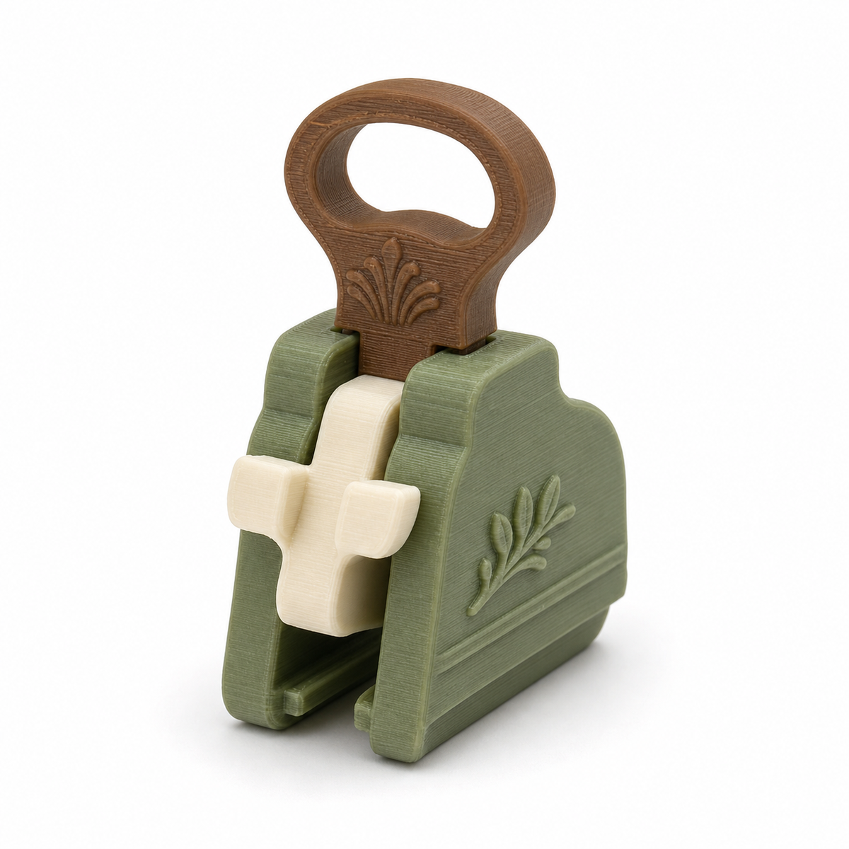 Product illustration of "curtain clamp with large handle ring" on white background: curtain clamp; Basic shape: compact clamping body with oval upper handle ring; Design: two opposite clamping jaws and a central bright closure; Colours: sage green, cream and brown.