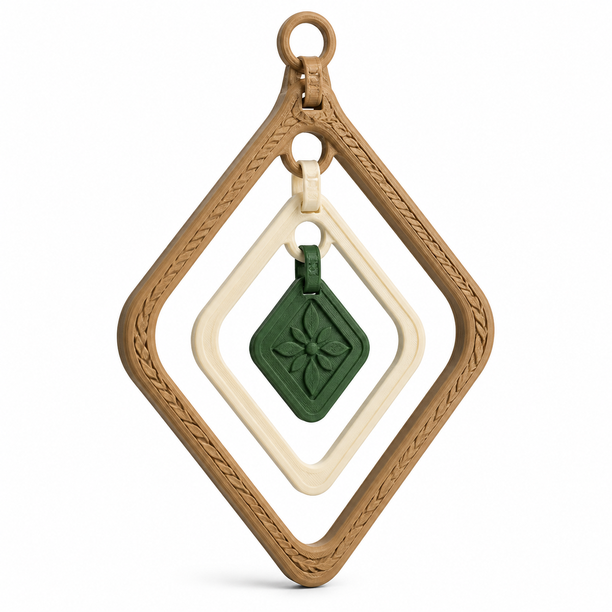 Product illustration of "Route shaped hanging decoration with leaf medallion" on white background: hanging decoration; Basic shape: large open diamond shape with small upper suspension loop; Design: three nested frames and a freely hanging square middle piece; Colours: natural brown, cream and dark green.