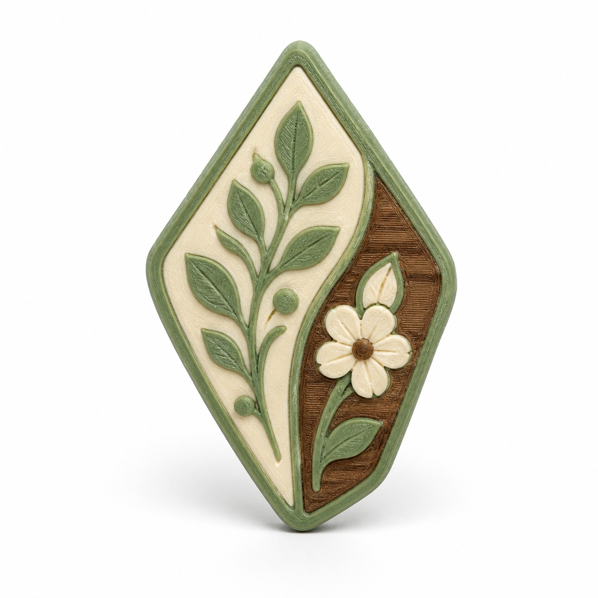 Rautenförmiger Magnet mit Blütenzweig – Produktansicht auf weißem Hintergrund; Farben: Salbeigrün, Creme und Braun.
