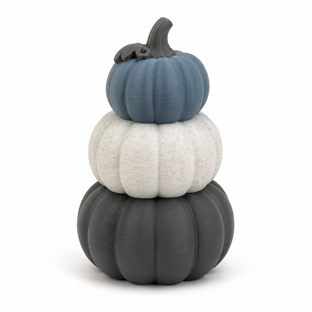 Product illustration of “Pump Tower in blue, white and grey” on white background: Autumn decoration; Basic shape: Tower made of three different sized pumpkins stacked on top of each other; Design: strong longitudinal ribs and a short curved stem; Colours: white, grey blue and dark grey.