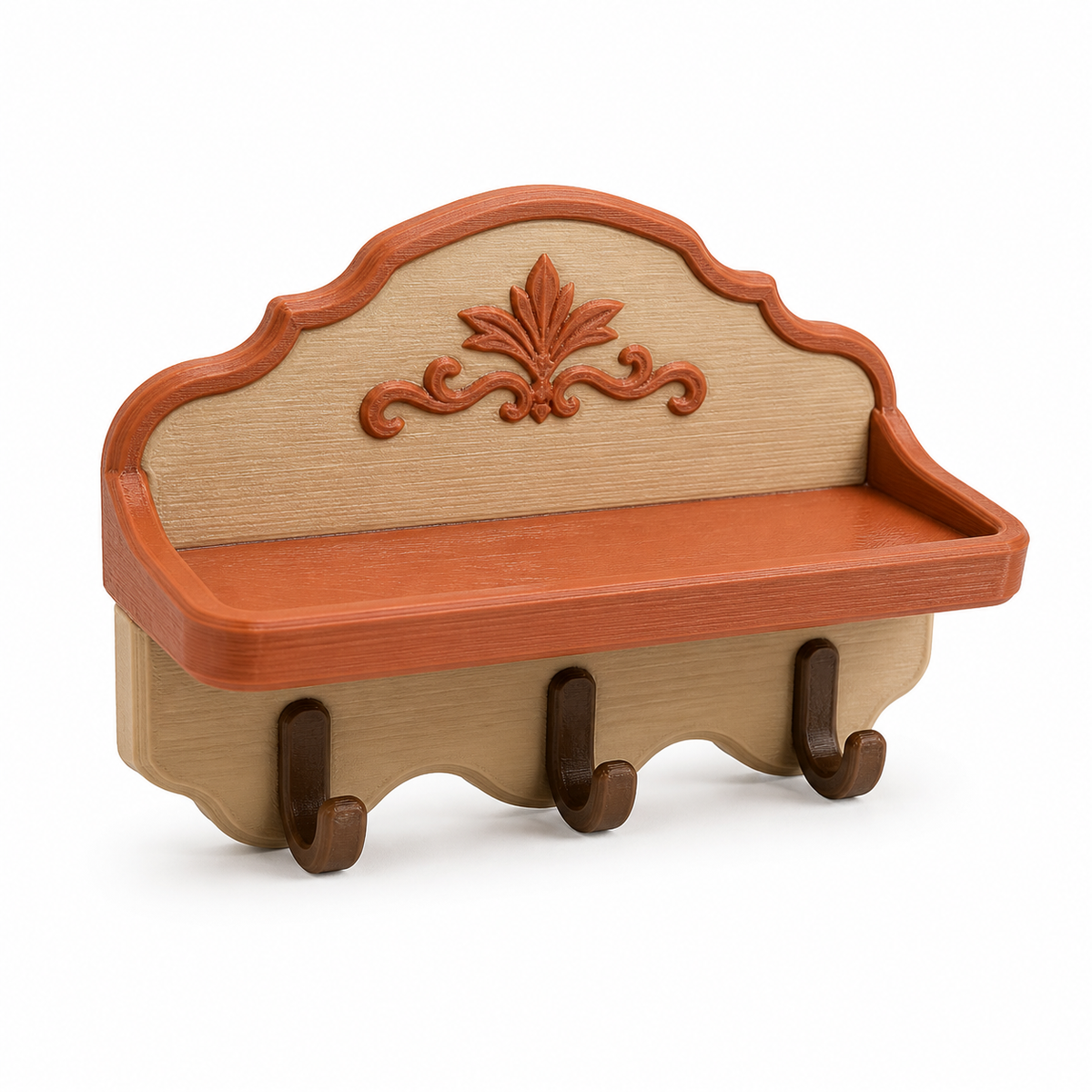 Product illustration of "wall shelf with three hooks and maple leaf" on white background: key tray; Basic shape: wide tray in front of a curved rear wall with three hooks; Design: a wave-shaped bottom edge and a large central leaf relief; Colours: terracotta, beige and brown.