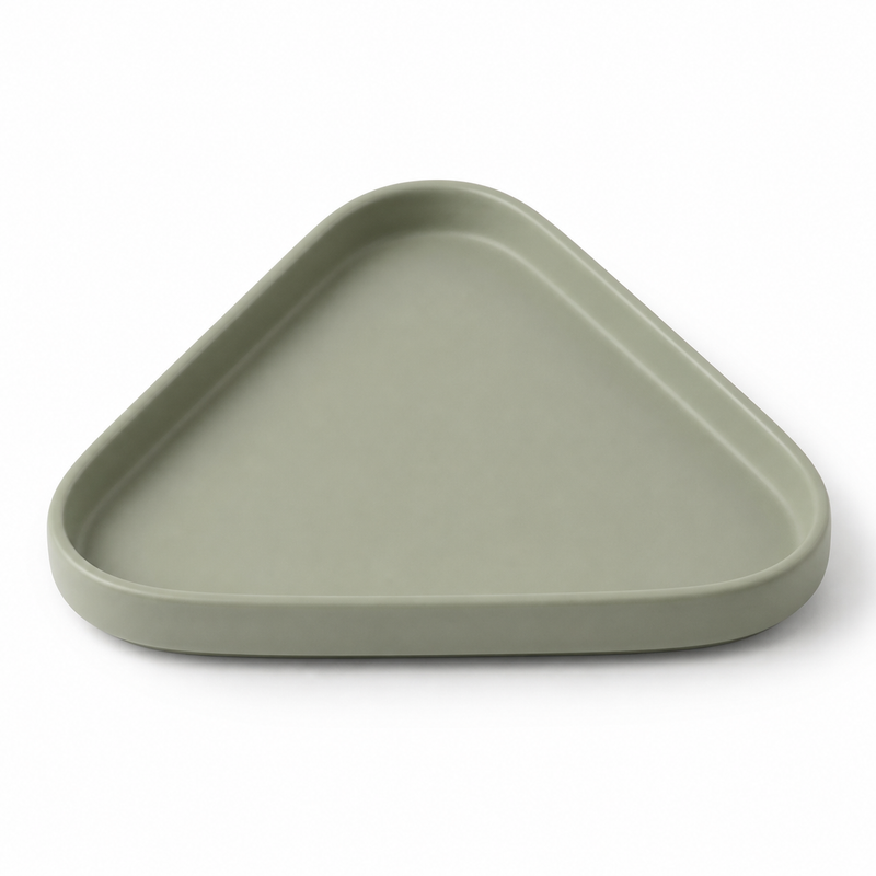 Sage green triangular decorative tray with strongly rounded tips, narrow raised edge and flat recessed center on white background.
