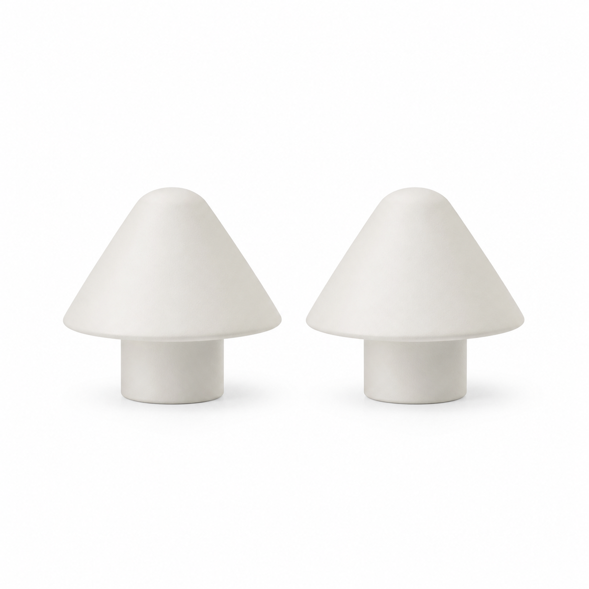 Two conical curtain rod endings in warm white on white background