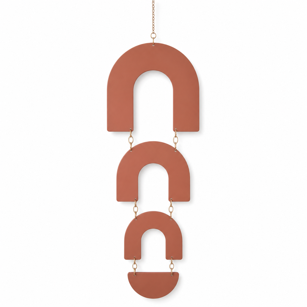 Terracotta-colored hanging decoration with three open round arches on white background