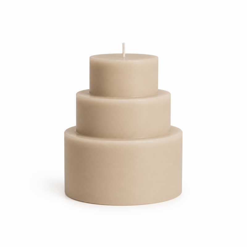 Sand beige step candle from three cylindrical levels on white background