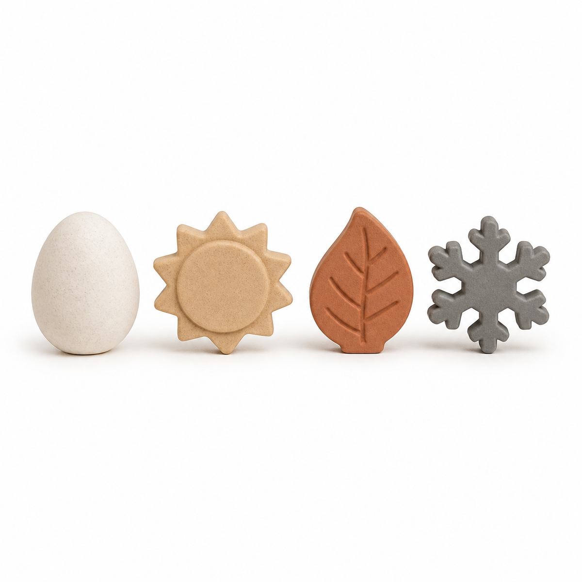 Four seasonal forms as egg, sun, leaf and snow crystal in natural tones