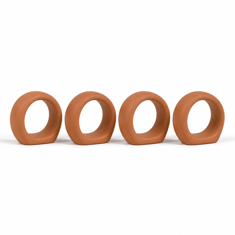 Four terracotta-coloured minimalist napkin rings as wide round loops