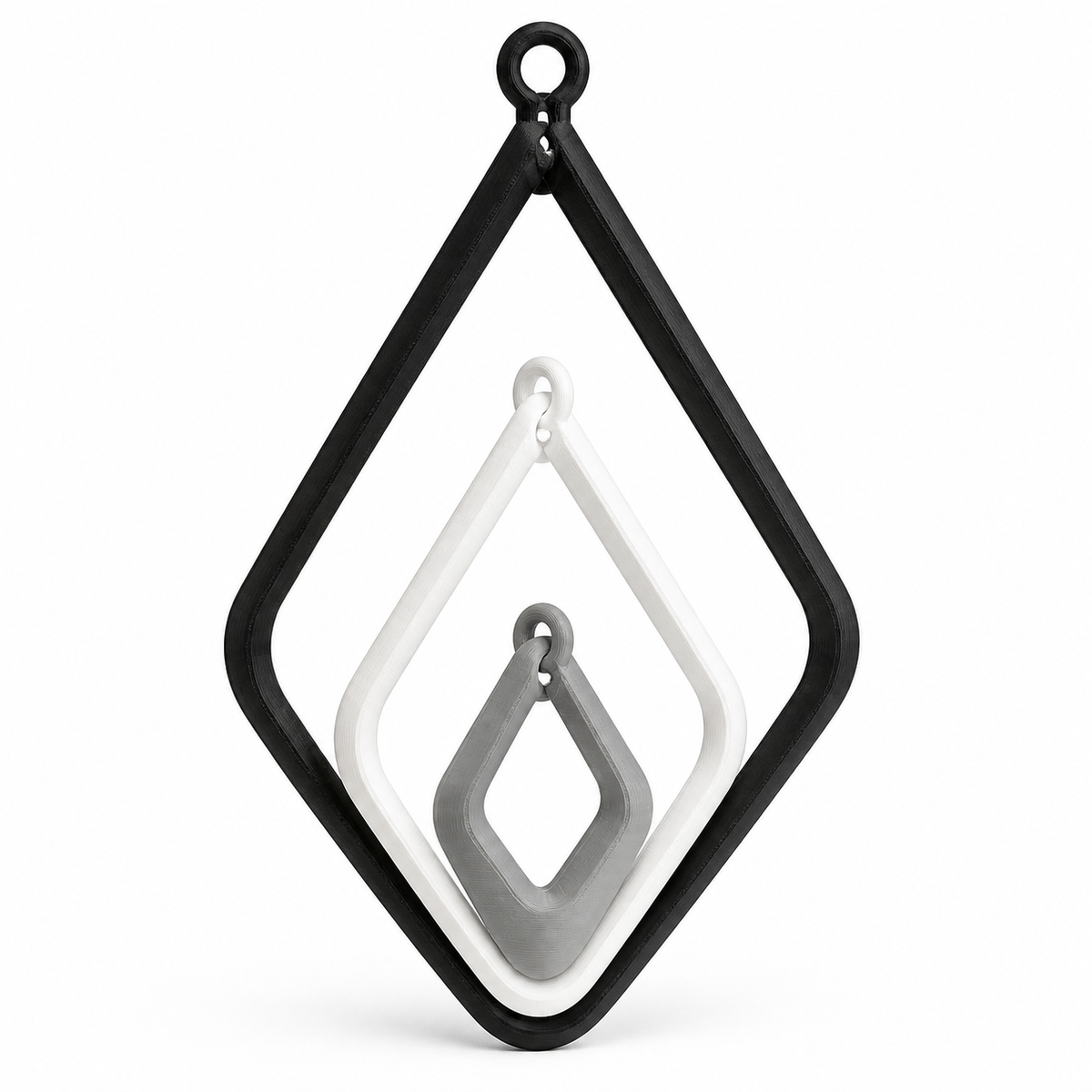 Product illustration of "Route-shaped hanging decoration with three frames" on a white background: hanging decoration; Basic shape: large open diamond shape with small upper suspension loop; Design: three nested geometric frames with free hanging inner rod; Colours: white, grey and black.