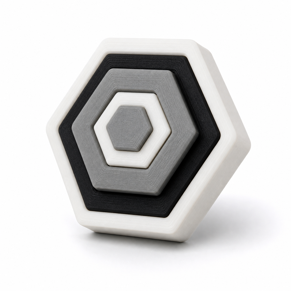Sechseckiger Magnet mit konzentrischen Rahmen – Produktansicht auf weißem Hintergrund; Farben: Weiß, Grau und Schwarz.