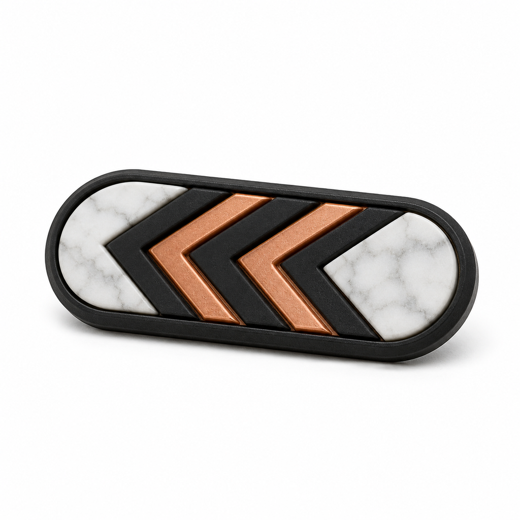 Länglicher Magnet mit Kupfer-Chevrons – Produktansicht auf weißem Hintergrund; Farben: Marmorweiß, Schwarz und Kupferfarben.