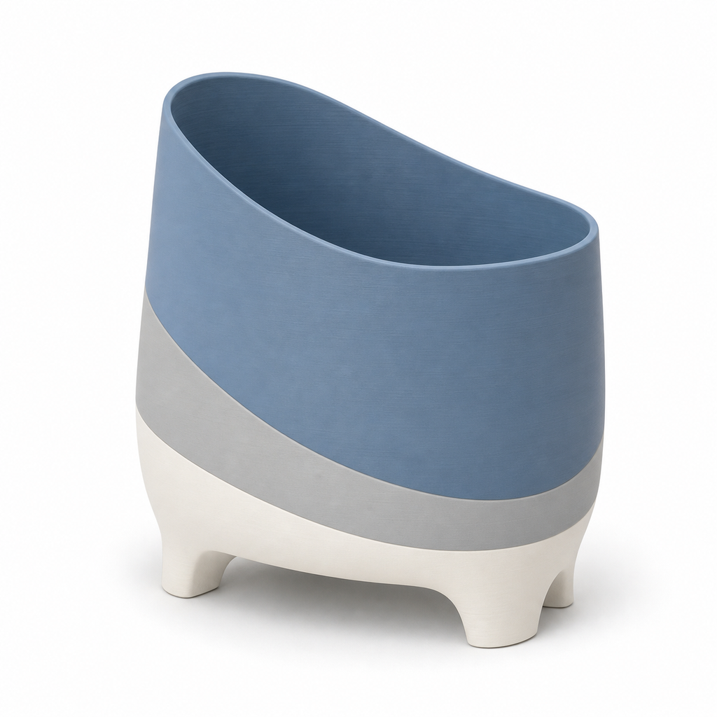 Product image of "Suitable plant pot in blue and grey" on white background: plant pot; Basic shape: slanted oval vessel shape on four short feet; Design: a distinctive inclined opening and soft rounded exterior walls; Colours: blue, grey and white.