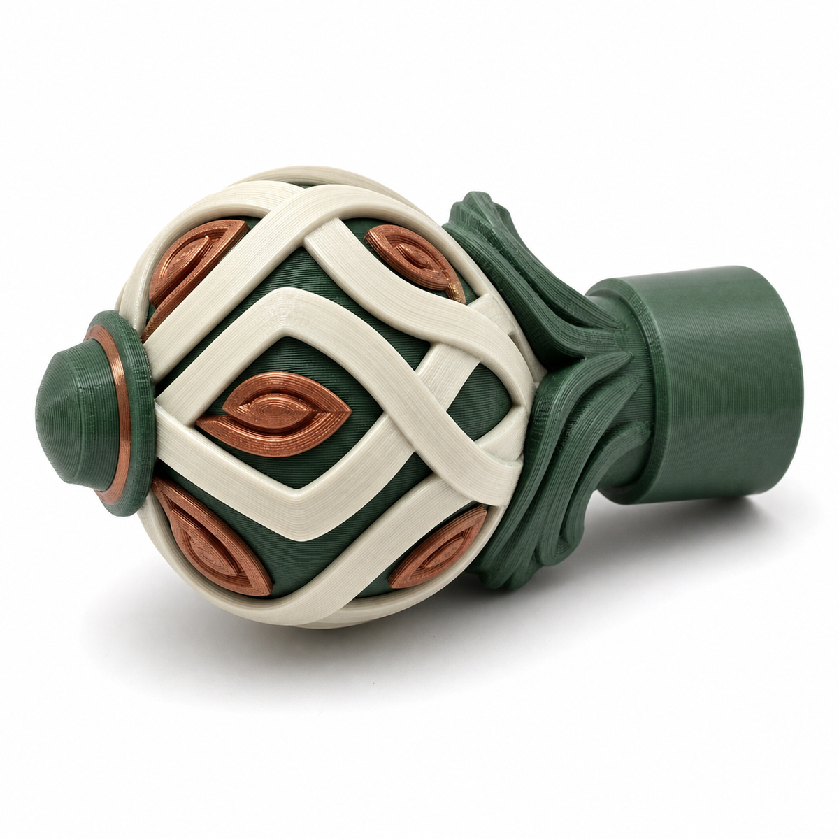 Product illustration by “Gardine rod end piece with knot ornament” on white background: Curtain rod end piece; Basic shape: conical spherical end shape with cylindrical approach; Design: circular cream-coloured braided bands and leaf-shaped copper-brown fields; Colours: dark green, cream and copper-brown.