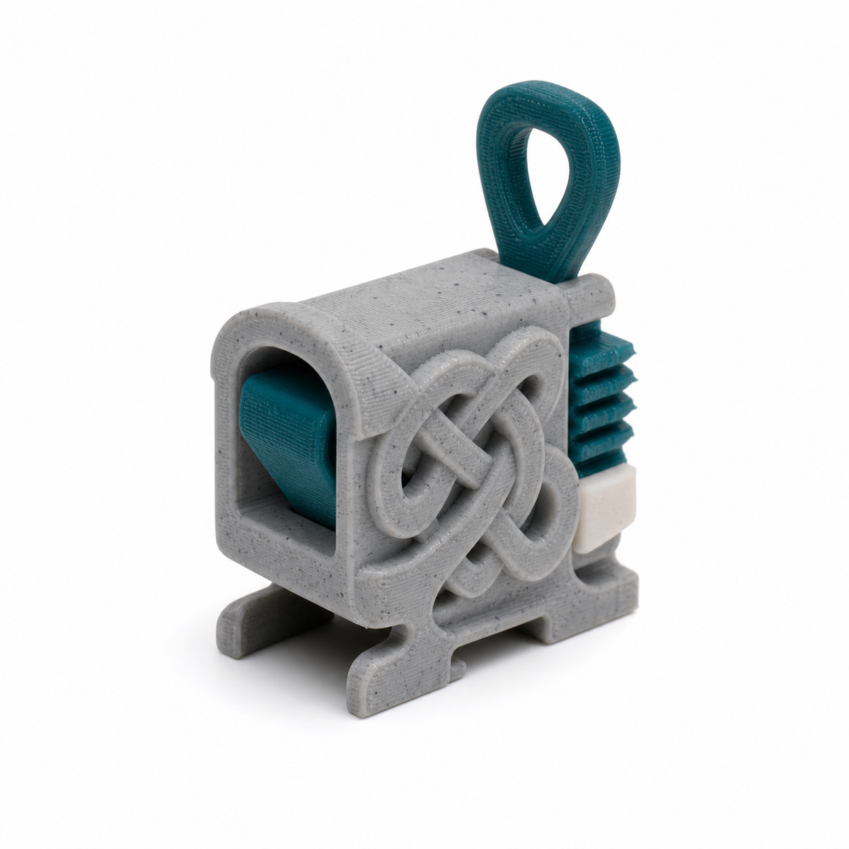 Product illustration of "Compact curtain clamp with rune grid" on a white background: curtain clamp; Basic shape: square clamping body with large upper loop; Design: a reliefed front knot field and laterally visible ribbed clamping parts; Colours: teal, silver grey and white.