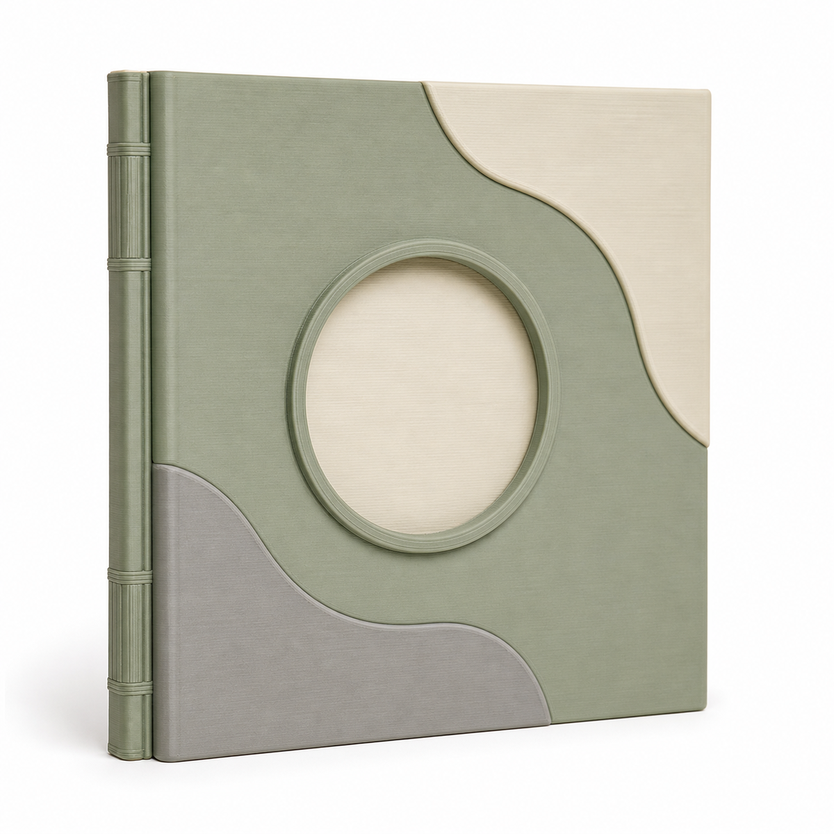 Product image of "photo album with round picture window and wave fields" on white background: photo album; Basic shape: high-format book-like album with salbei green back; Design: a large oval picture window and organically layered cover surfaces; Colours: sage green, cream and light grey.
