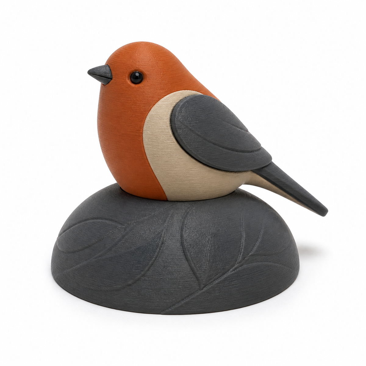 Product illustration of "red throat figure on leaf base" on white background: bird figure; Basic shape: sitting little bird on a flat organic base; Design: soft modeled wings, chest and a reliefed large leaf; Colours: terracotta, cream and anthracite.