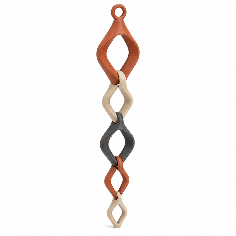 Product illustration of "Smal hanging decoration with wave chain" on white background: hanging decoration; Basic shape: long vertical chain of five curved diamond and S elements; Design: alternating large and small open shapes with quiet rhythm; Colours: terracotta, cream and anthracite.