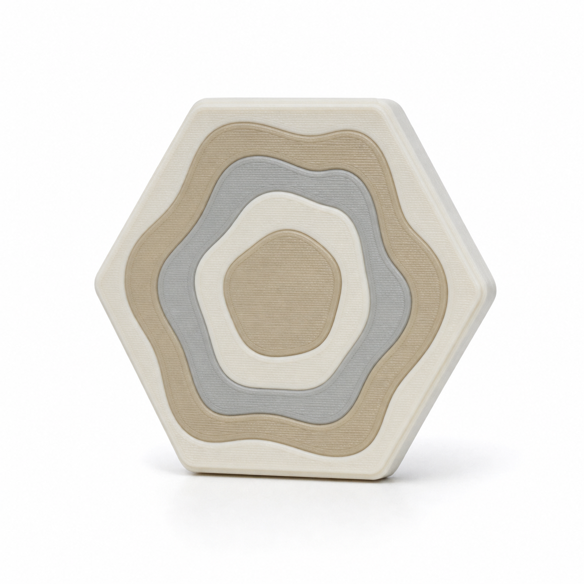Sechseckiger Magnet mit ruhigen Höhenringen – Produktansicht auf weißem Hintergrund; Farben: Cremeweiß, Beige und Hellgrau.