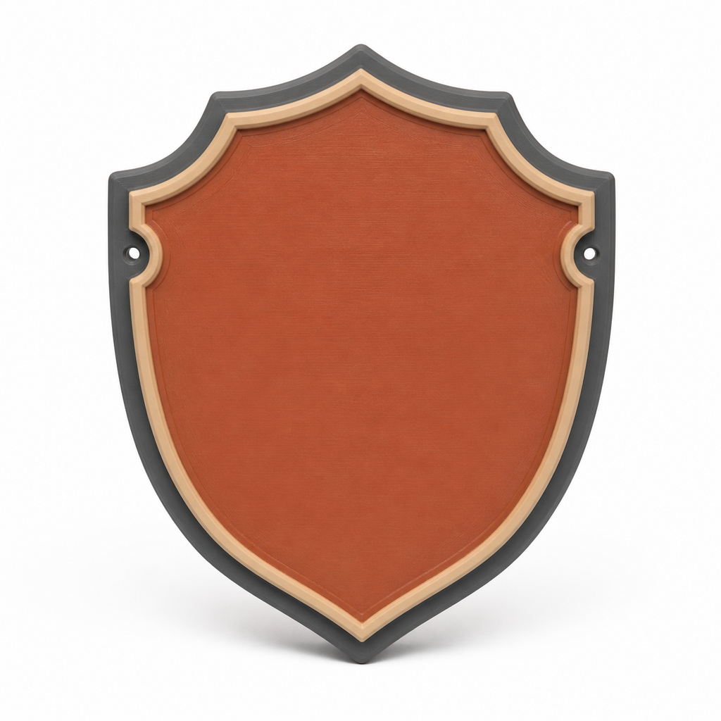 Product illustration by “Shield-shaped door sign in terracotta” on a white background: door sign; Basic shape: high downwards pointed coat of arms with two lateral eyes; Design: a curved cream-coloured inner frame and dark outer edge; Colours: terracotta, cream and anthracite.