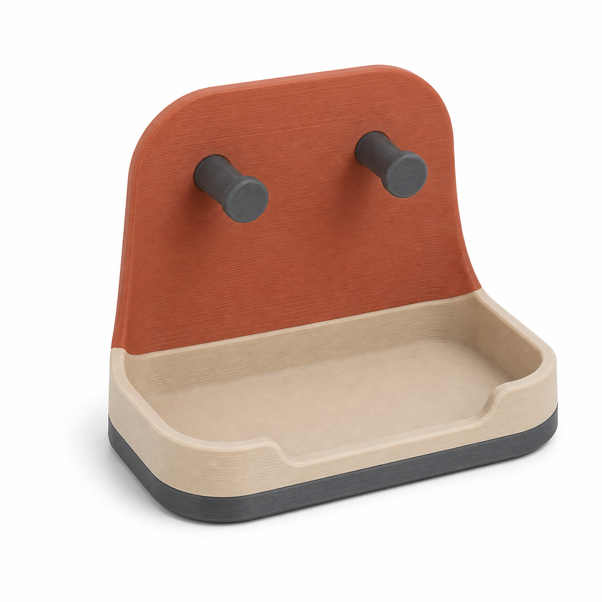 Product illustration of "Compact key tray in terracotta" on a white background: key tray; Basic shape: rounded back wall with two dark pens over a deep shelf; Design: a soft two-colour front section and a dark base; Colours: terracotta, cream and anthracite.