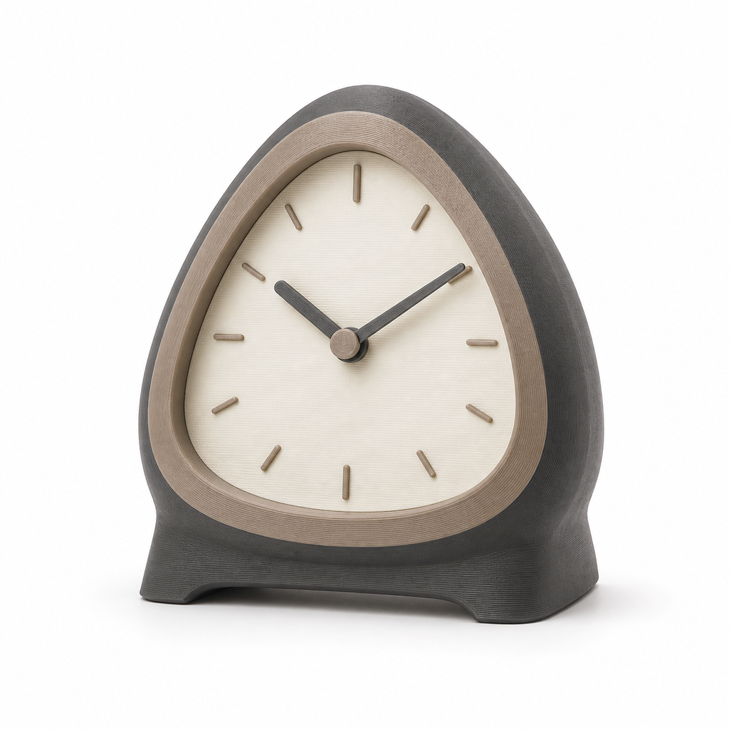 Product illustration of "Triangular table clock in anthracite and taupe" on white background: table clock; Basic shape: soft triangular watch case on a dark wide foot; Design: a bright quiet dial with simple line indices; Colours: anthracite, taupe and cream.