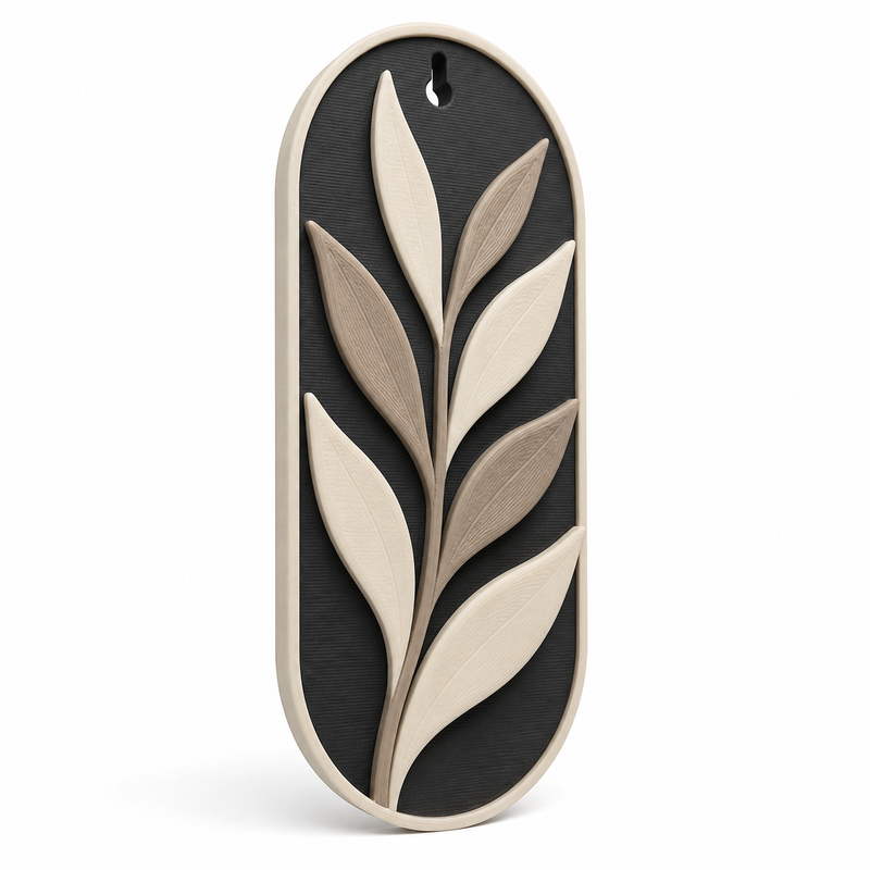 Product illustration of "Long wall ornament with calm leaf branch" on white background: wall ornament; Basic shape: high rounded reliefplatte with upper suspension opening; Design: a large aspiring branch with seven gently shaped leaves; Colours: anthracite, taupe and cream.