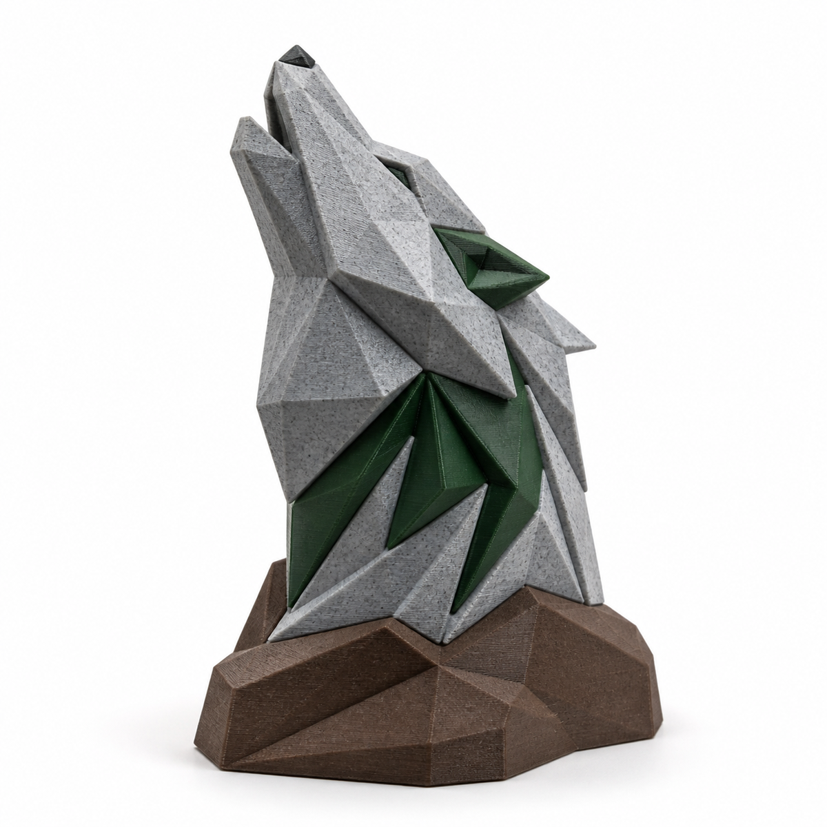 Product image of "Wolfsskulptur Bergwacht" on white background: Deco sculpture; Basic shape: squared, looking wolf head on compact base; Design: faceted surfaces with jagged coats; Colours: stone grey, Forest green and brown.