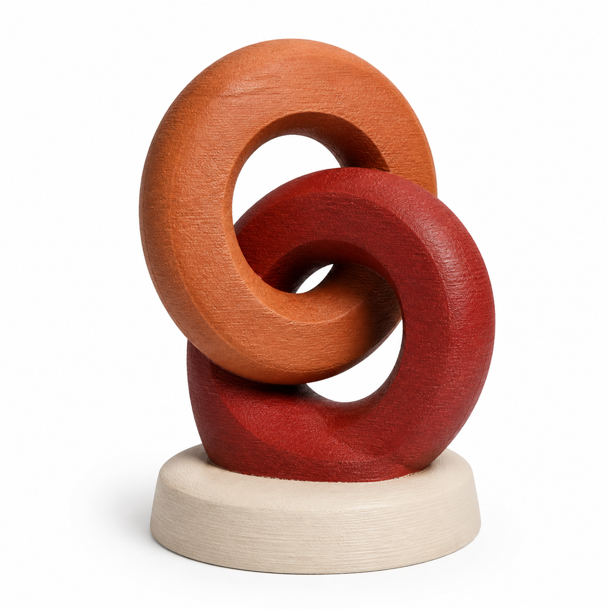 Product image of “Sculpture Harvest Bund” on a white background: Deco sculpture; Basic shape: two interlocking round shapes on a light base; Design: reduced, soft rounded knot silhouette; Colours: terracotta, Dark red and cream.