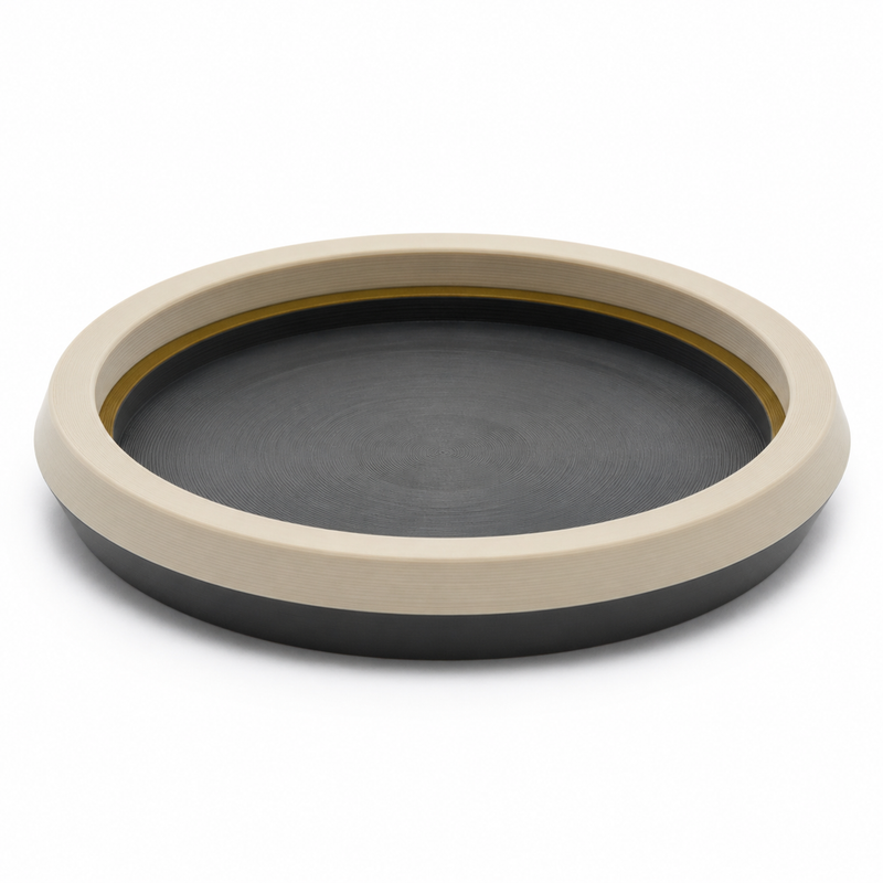 Product illustration of “Round tray ivory ring” on white background: decorative tray; Basic shape: flat round tray with wide raised edge; Design: quiet dark interior and clear graduated exterior contour; Colours: ivory, dark grey and gold.