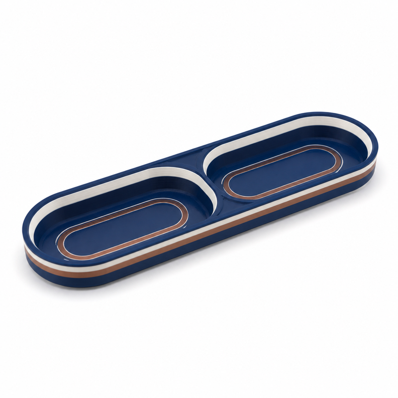 Product image of "Double tray night copper" on white background: decorative tray; Basic shape: long rounded tray with two adjacent troughs; Design: symmetrically divided shelf surfaces and clear double contour; Colours: dark blue, copper and navy blue.