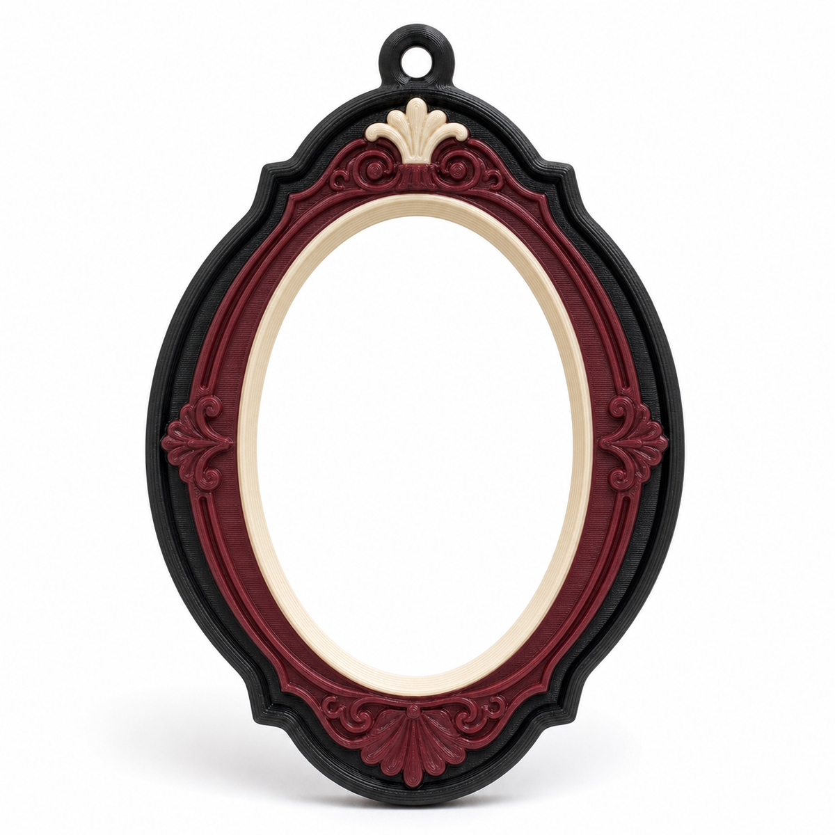 Product illustration by “Photo frame Bordeaux ornament” on white background: photo frame; Basic shape: high oval frame with small upper suspension eye; Design: plastic floral ornaments on head and foot; Colours: Bordeaux, cream and black.